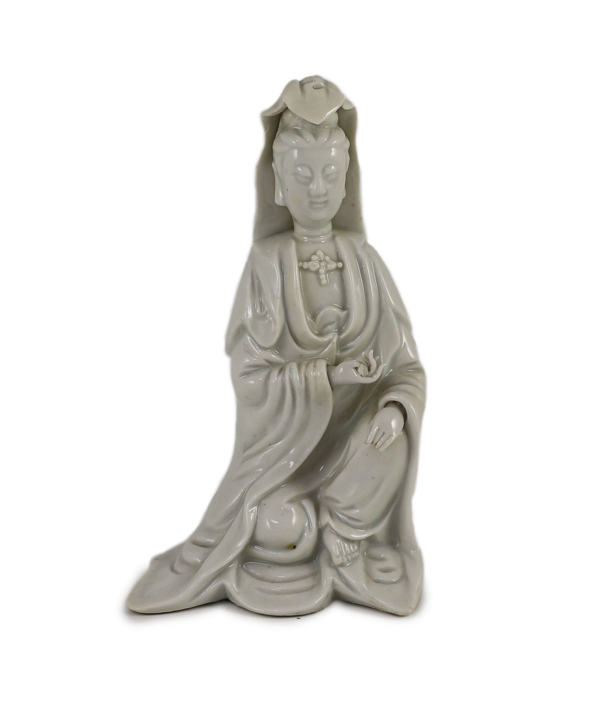 A Chinese blanc-de-chine seated figure of Guanyin, Dehua kilns, 18th century, 19cm high, losses to hand
